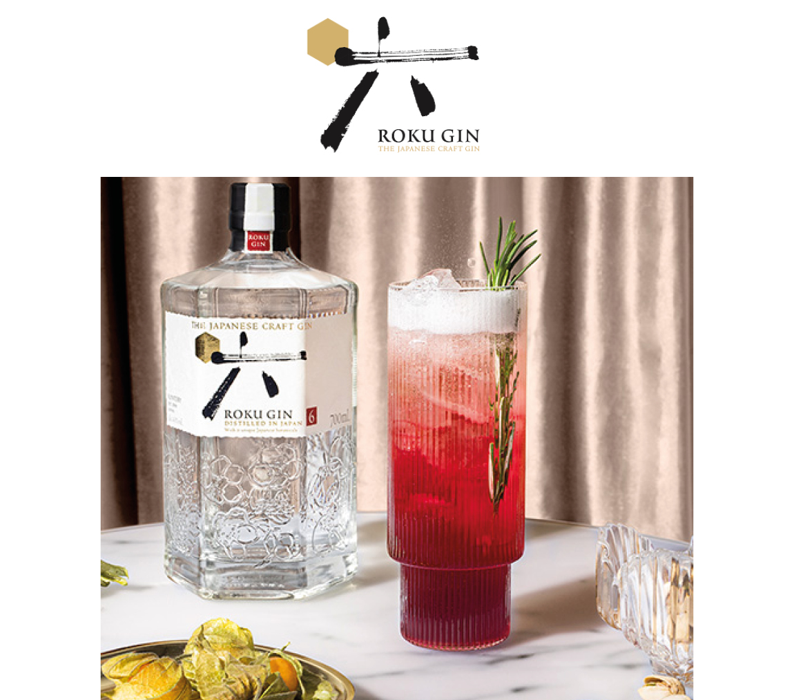 Roku Gin Flasche mit dem Coacktail Roku WInter Spritz in einem Glas auf einem Tisch
